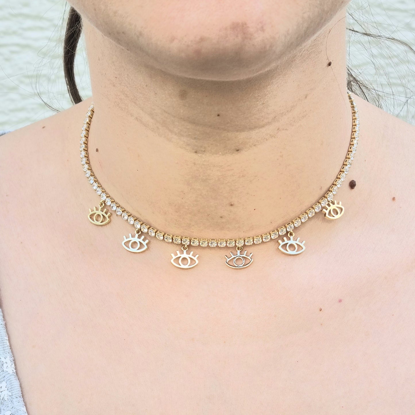 CHOKER ZIRCONIA CON DIJES DE OJOS CON PESTAÑAS EN CHAPA DE ORO